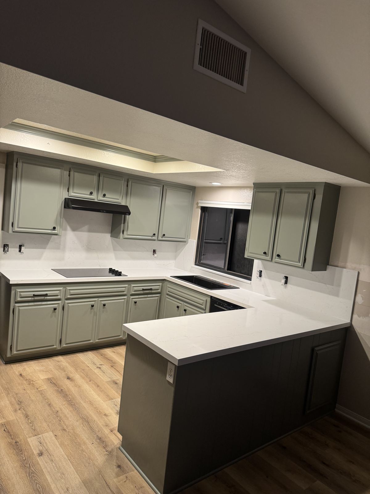 U-shaped kitchen in white quartz, black undermount sink — kitchen countertop installation