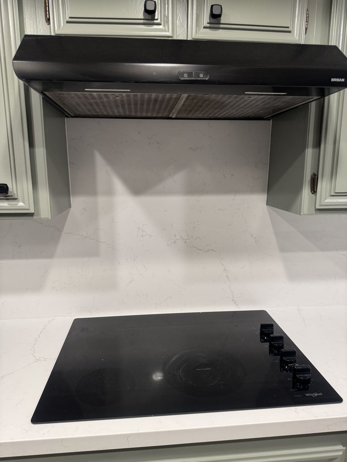 Full-height quartz backsplash at the cooktop — kitchen countertop installation