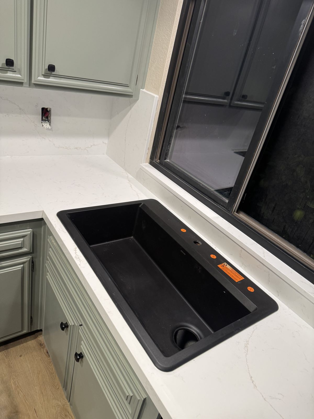 Matte black Kohler sink, undermount in quartz — kitchen countertop installation