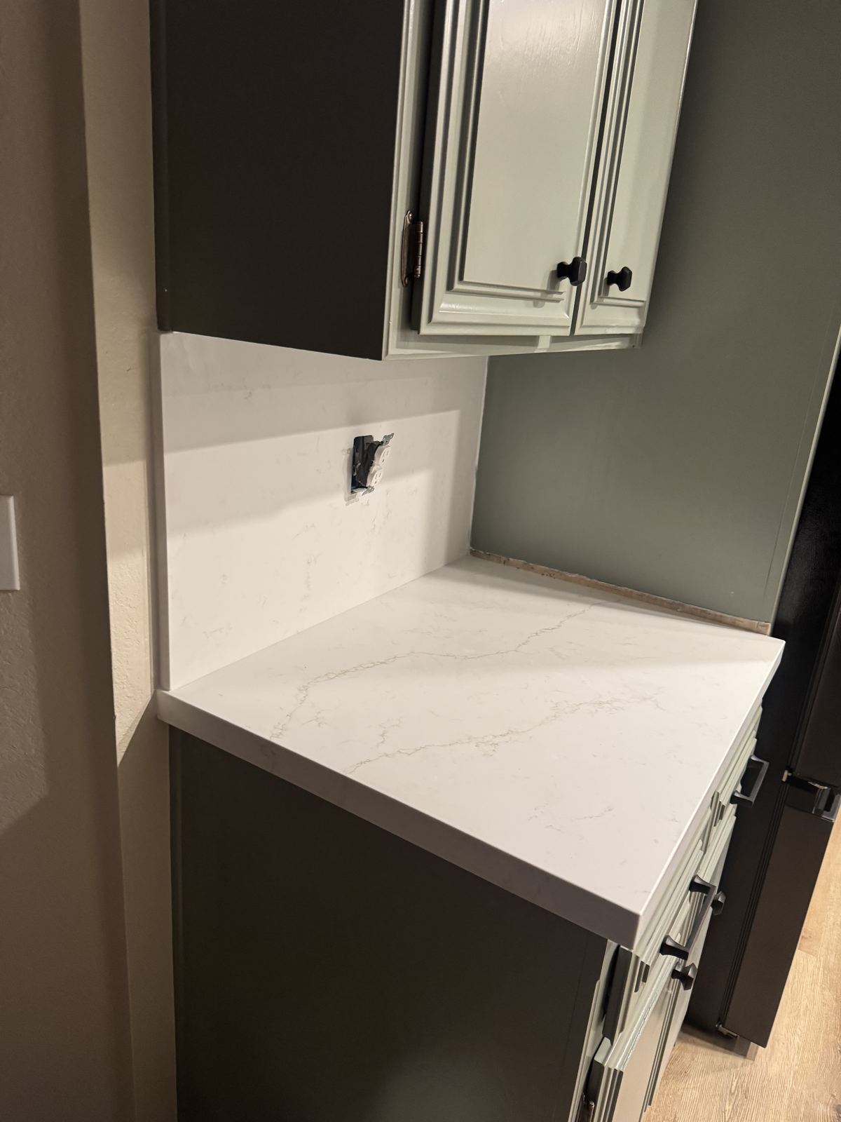 Corner counter with full-height side splash — kitchen countertop installation