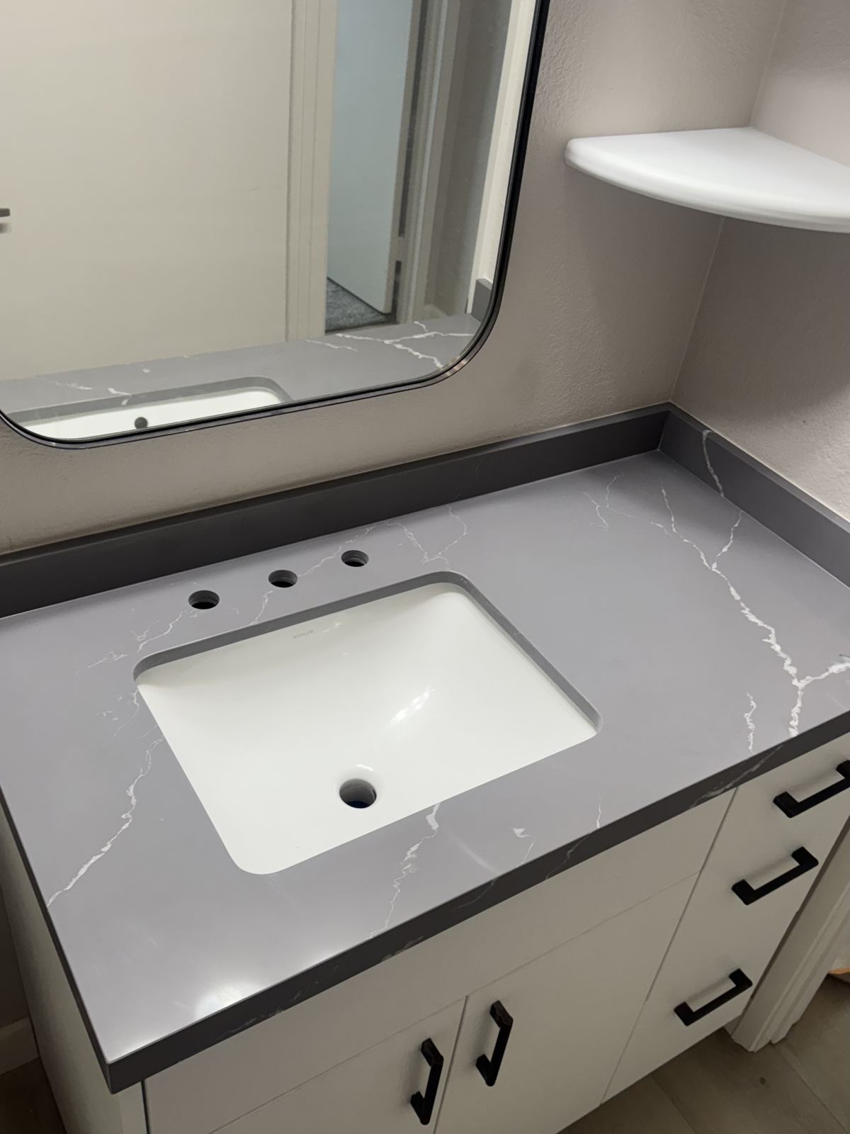 Gray quartz vanity, white Kohler undermount — bathroom vanity countertop