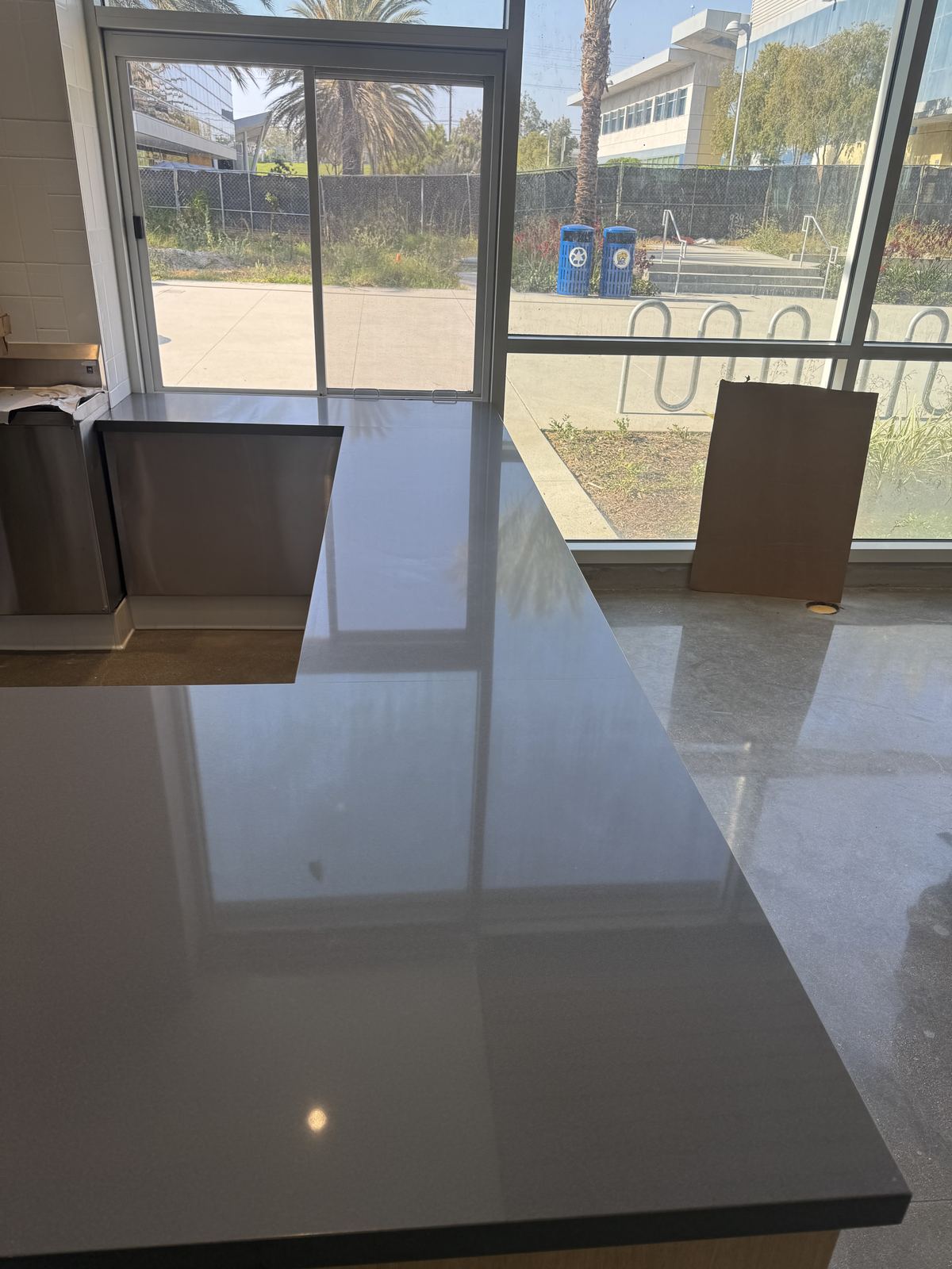 Gray quartz counters at the service window — commercial countertop installation